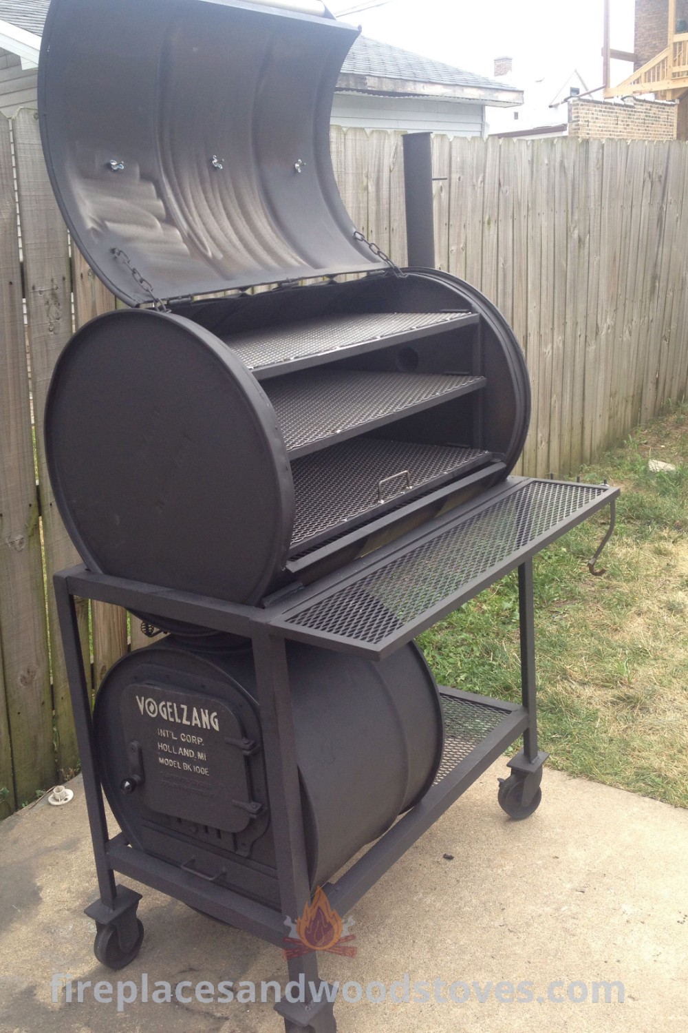 A stylish barrel grill smoker placed on a cement ground next to a fence, enhancing your outdoor cooking area with creative designs for a cozy BBQ experience. Discover more ideas for transforming your backyard at patioandhomefurniture.com.