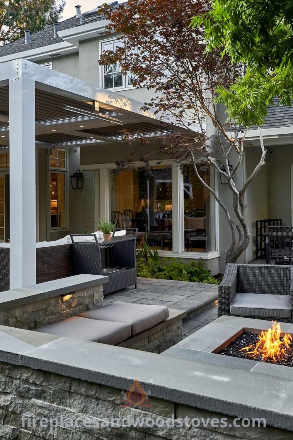 An outdoor patio with seating and fire pit, showcasing a built-in grill patio design that enhances functionality and style. Perfect for backyard gatherings, find more patio ideas at patioandhomefurniture.com.