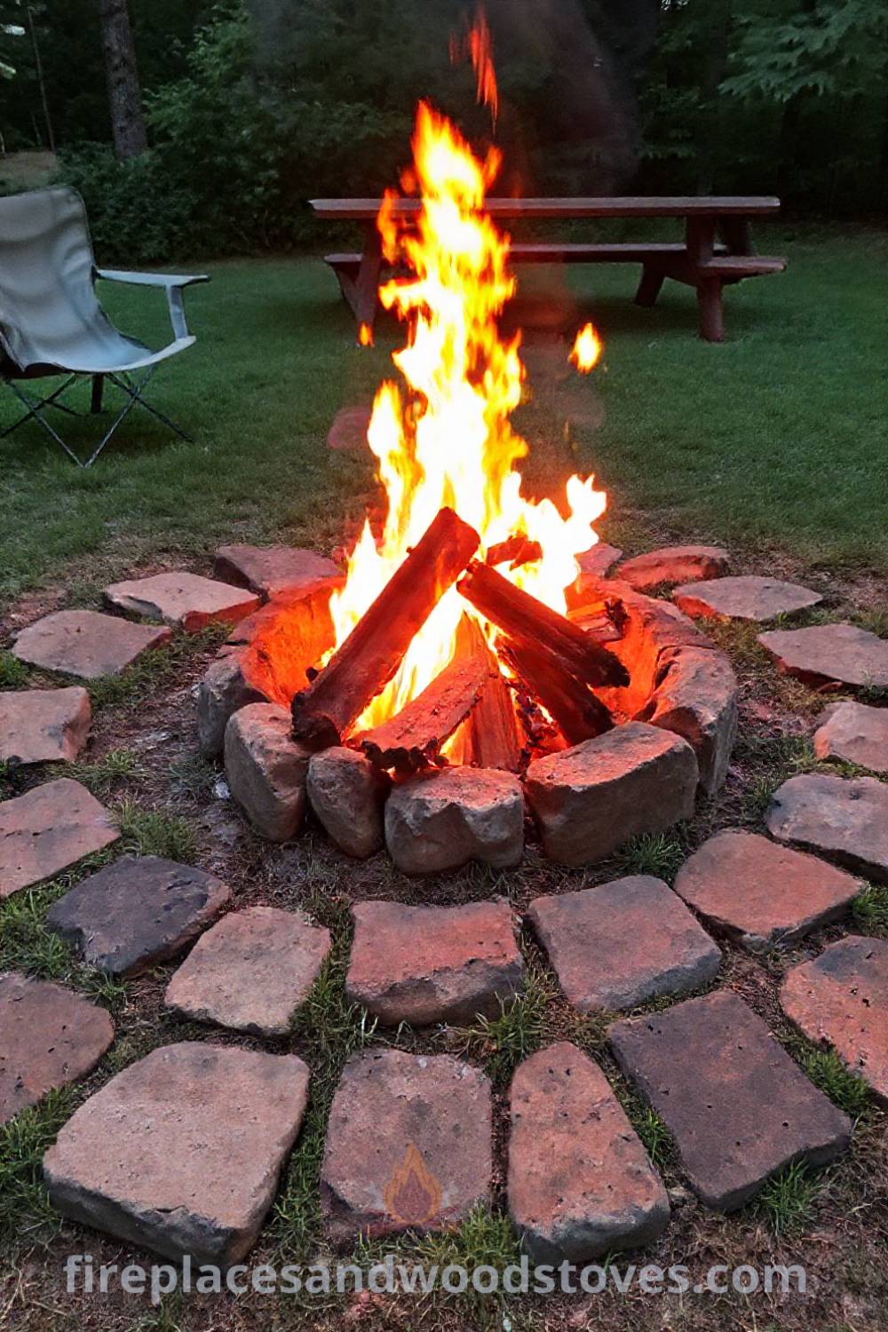 Rugged outdoor fire pit surrounded by uneven stones in a grassy backyard, inviting family and friends to gather around for stories and s