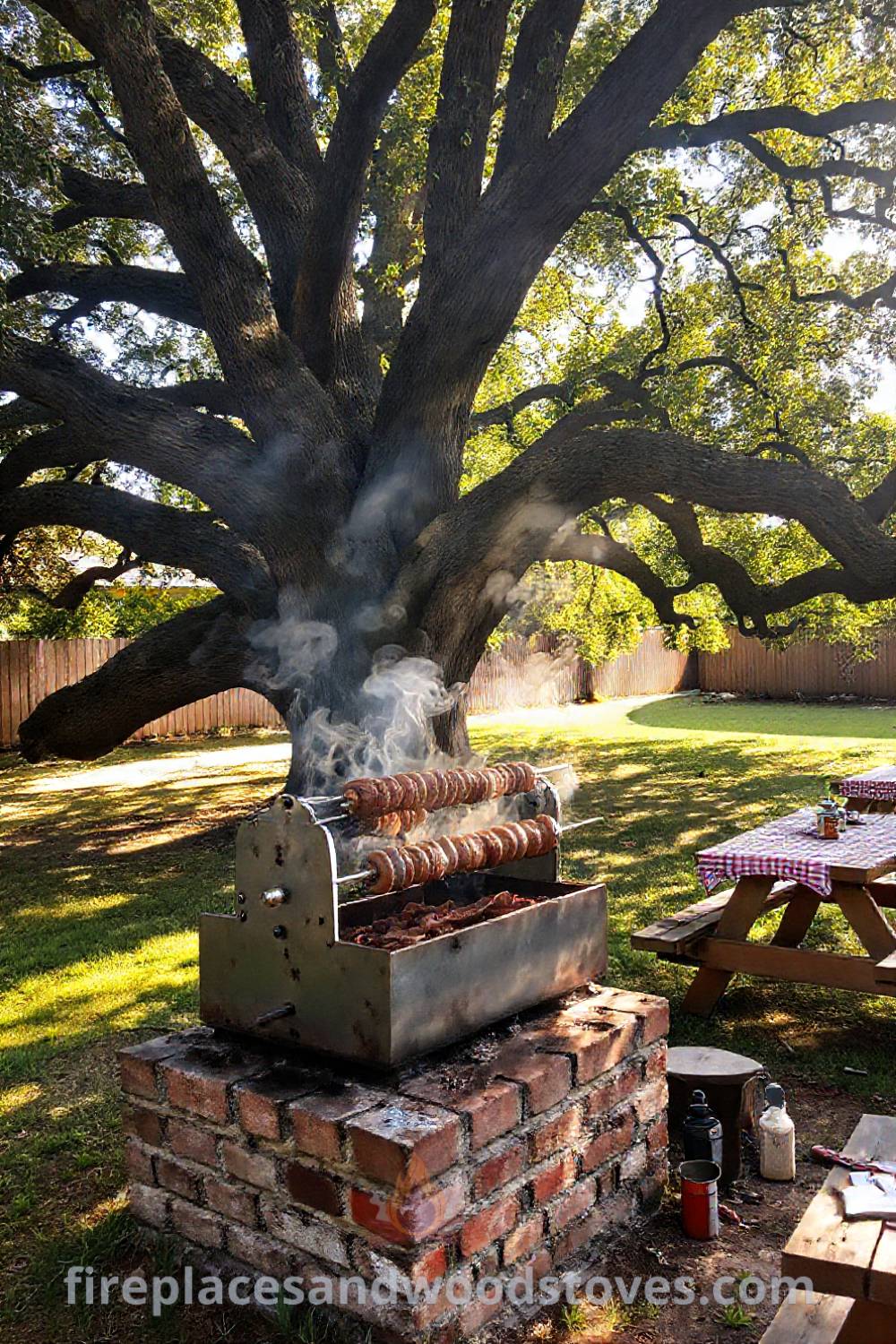 Backyard barbecue scene with a rotisserie grill under an oak tree, featuring checkered tablecloths, cooking tools, and an inviting atmosphere perfect for gatherings. Visit patioandhomefurniture.com for incredible outdoor design ideas that will wow your guests.