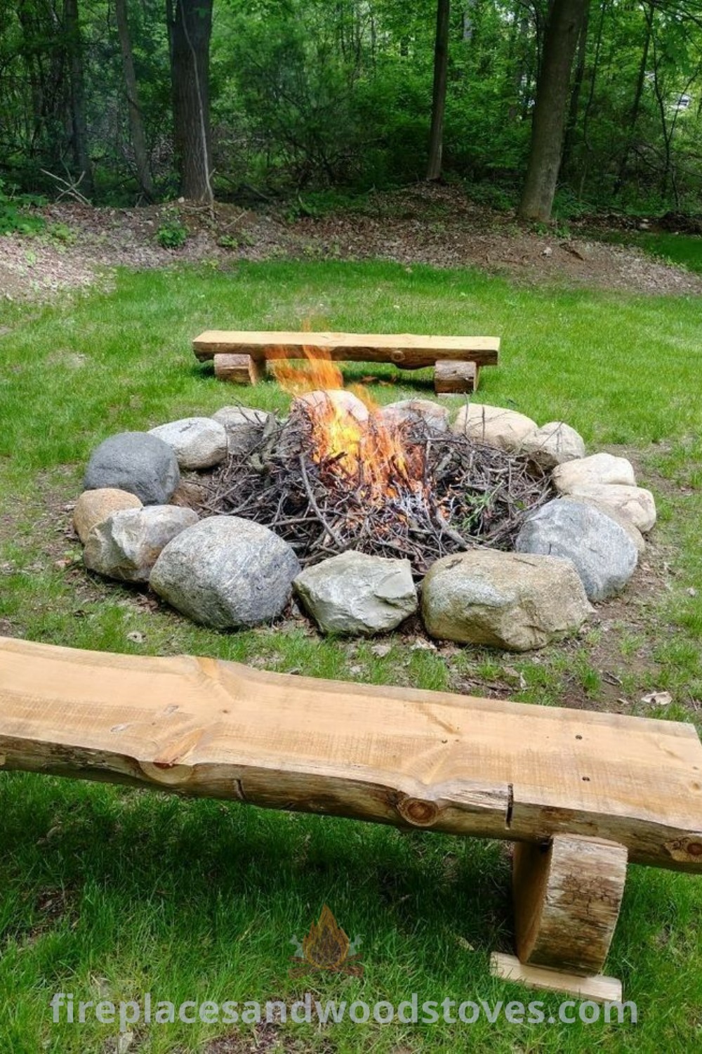 A wooden bench next to a paver fire pit on a lush green field, creating a cozy outdoor setting perfect for bonfire ideas and backyard gatherings. Explore stylish outdoor fire pit designs and landscaping inspiration at patioandhomefurniture.com.