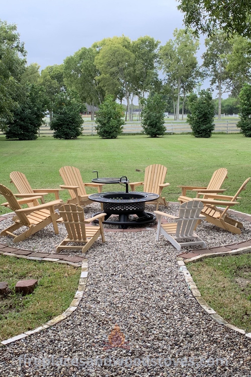 A fire pit surrounded by chairs in a park, featuring stylish landscaping and creative garden ideas, offering a relaxing outdoor space for gatherings. Discover more incredible ideas for backyard fire pits at patioandhomefurniture.com.
