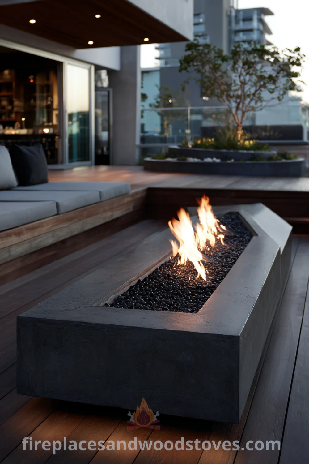 Modern fire pit with sleek basalt design, black fire glass, and minimalist garden setting for a cozy ambiance.