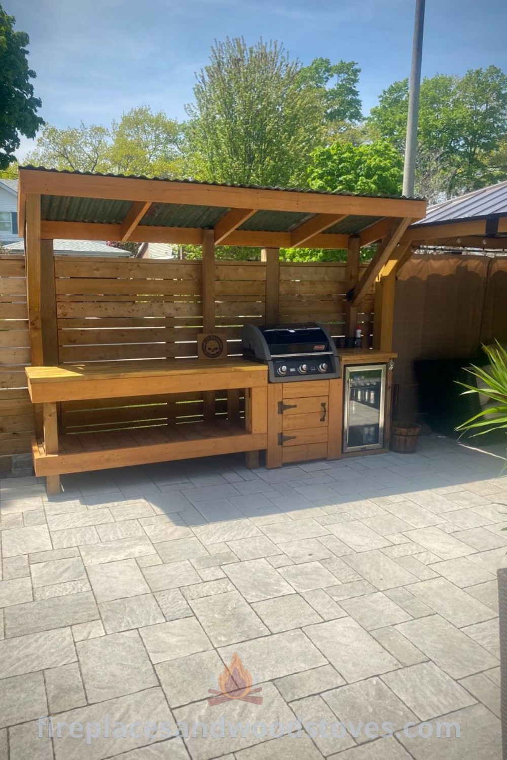 An outdoor kitchen area with a grill and sink, showcasing a stylish grill corner and cozy grill shelter, ideal for creating the ultimate outdoor dining experience. Discover more ideas that will wow your guests at patioandhomefurniture.com.