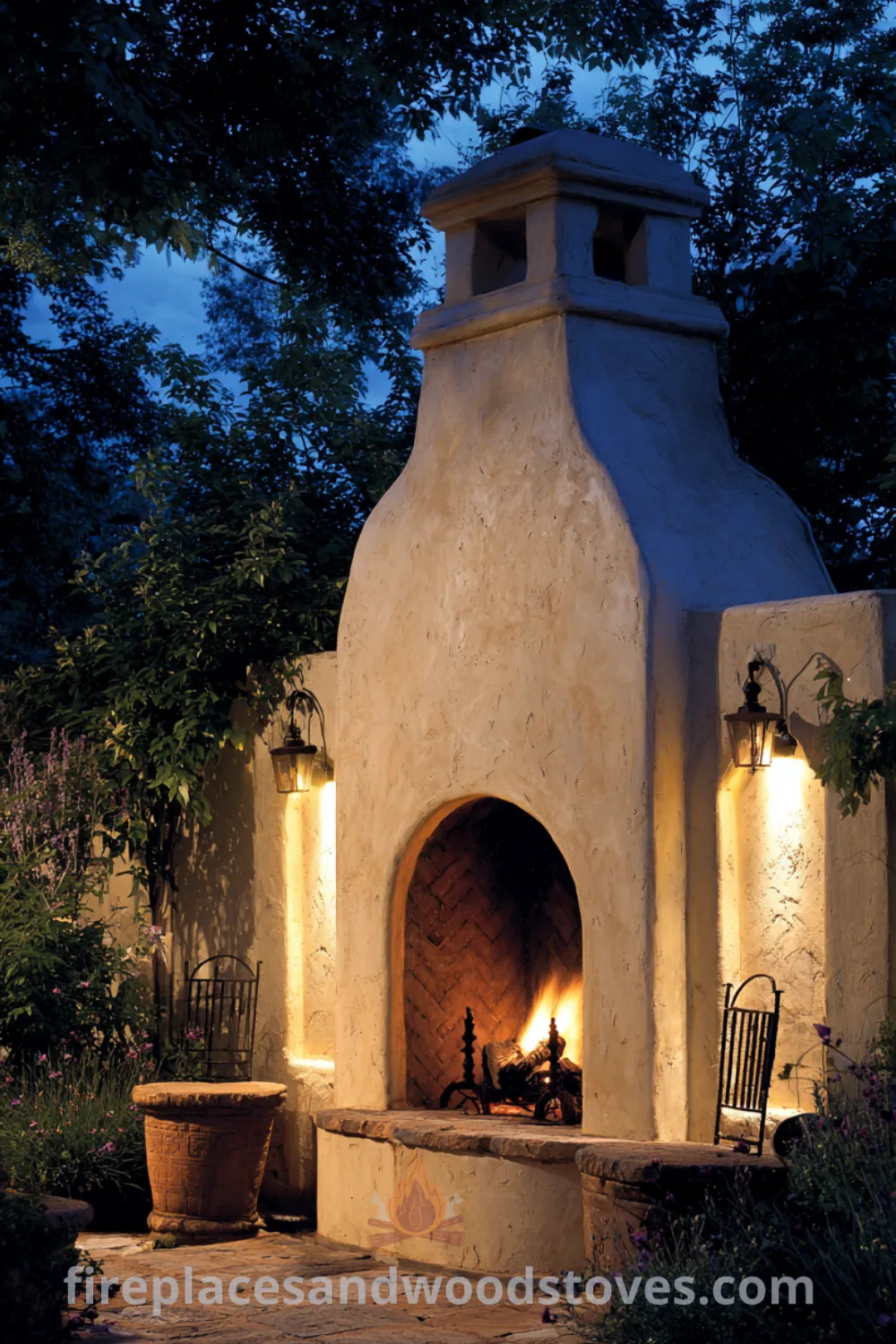 Mediterranean rustic outdoor fireplace surrounded by rustic furniture, warm evening glow, and earthy outdoor fireplace design elements.