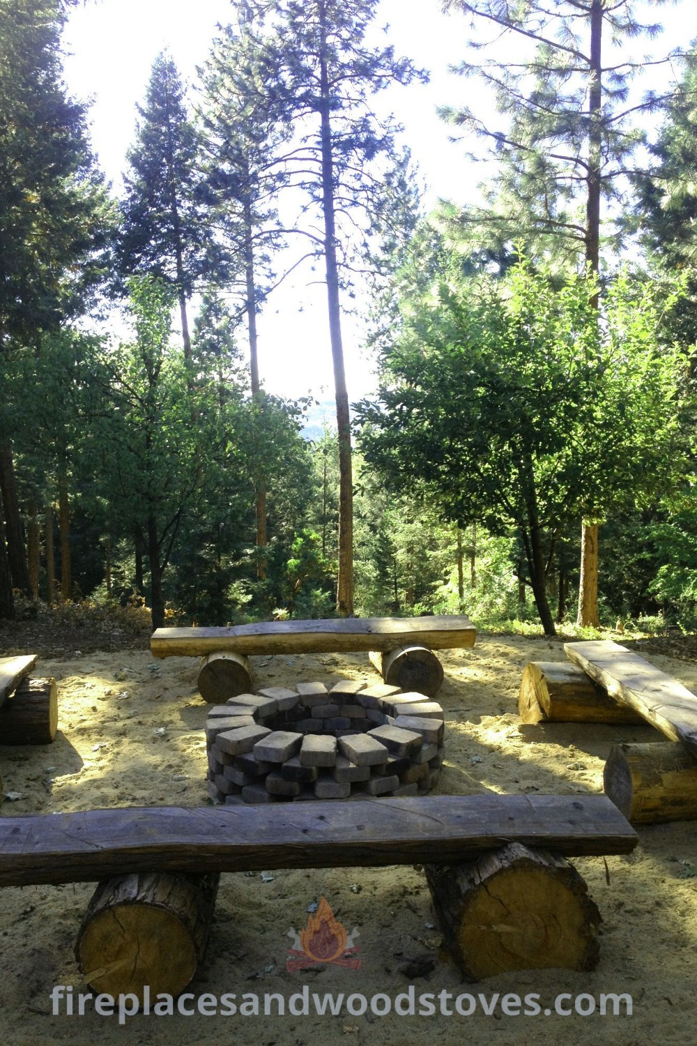 A rustic campfire area in the woods featuring log seating and benches, perfect for creating a cozy backyard campsite. Discover stylish outdoor designs and incredible ideas for transforming your garden at patioandhomefurniture.com.