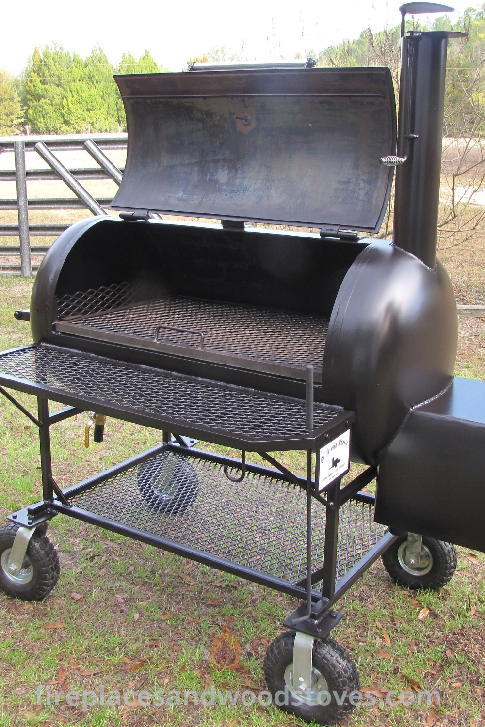 An outdoor oil drum BBQ grill set on a grass-covered field, showcasing a stylish design that elevates backyard cooking experiences. Discover custom smokers and incredible DIY barbecue ideas at patioandhomefurniture.com.
