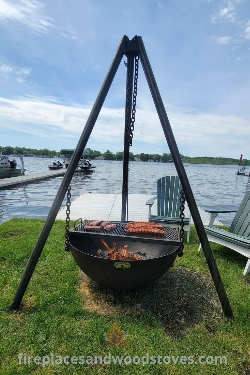 A cozy fire pit on a lush green field next to a body of water, creating a stylish and inviting atmosphere for outdoor gatherings. Discover incredible outdoor decor ideas at patioandhomefurniture.com.
