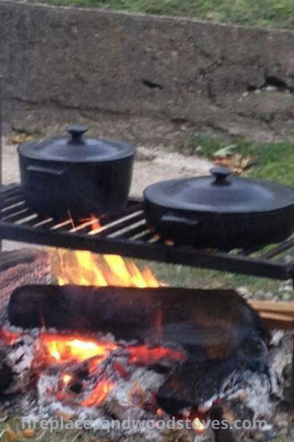 An outdoor grill with pots and pans cooking over an open fire in the grass, showcasing rustic charm and functionality. Ideal for creating memorable outdoor cooking experiences, this setup is part of patioandhomefurniture.com’s collection of cowboy kitchen and camping cooking equipment.