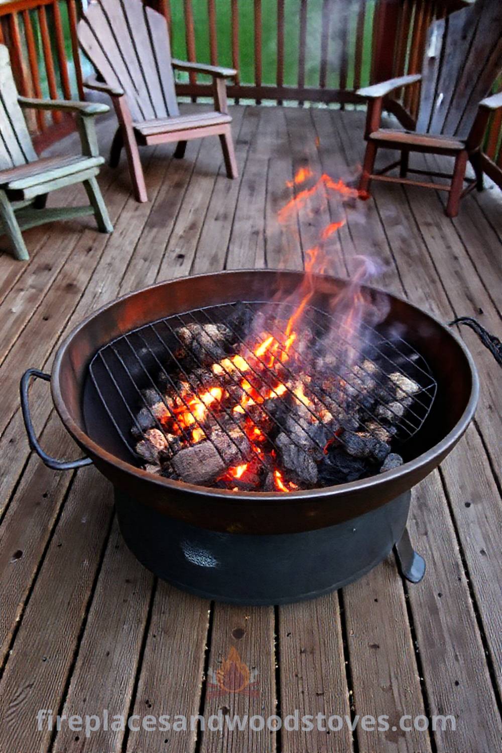 Durable metal fire pit on a wooden deck, surrounded by mismatched chairs, inviting friends to gather around the flickering flames and enjoy summer barbecues. Visit patioandhomefurniture.com for stylish outdoor designs transforming your backyard into a cozy gathering space.