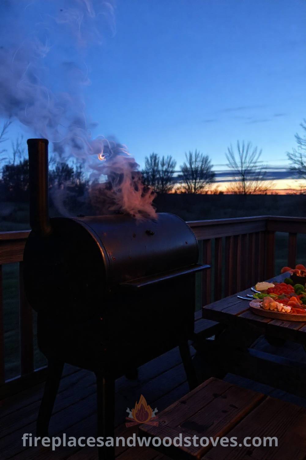 Sturdy barbecue smoker on a wooden deck with smoke curling from the chimney, surrounded by vibrant food ingredients on a rustic table, creating a cozy gathering space. Visit patioandhomefurniture.com for incredible ideas that will wow your guests in your outdoor design.