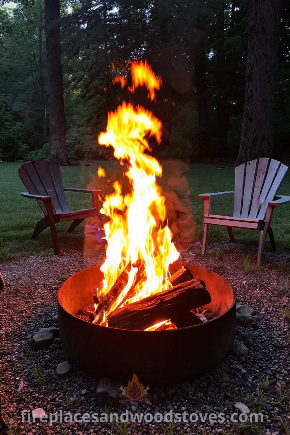Backyard charcoal camping fire pit surrounded by mismatched chairs, flames flickering against nearby trees, creating a cozy and inviting atmosphere for gatherings. Visit patioandhomefurniture.com for stylish outdoor design ideas that will wow your guests.