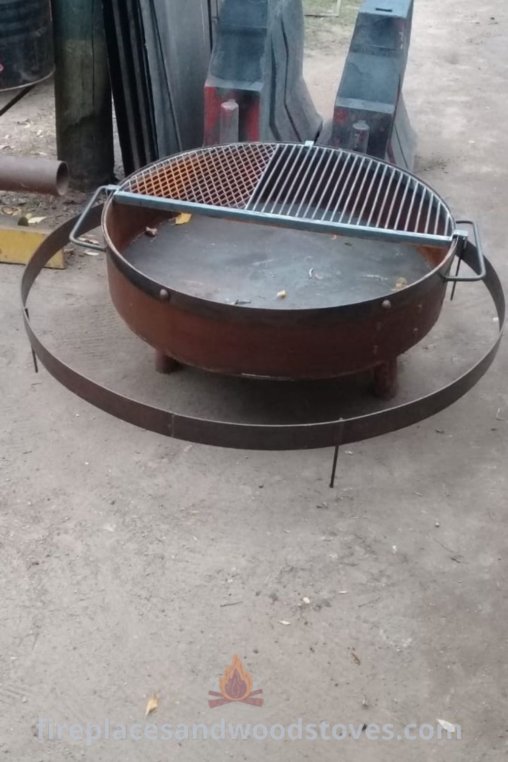 An outdoor BBQ grill positioned on the ground surrounded by a beautifully designed fireplace wall and fire pit landscape, showcasing ideal garden backyard aesthetics. Discover more outdoor dining ideas at patioandhomefurniture.com.