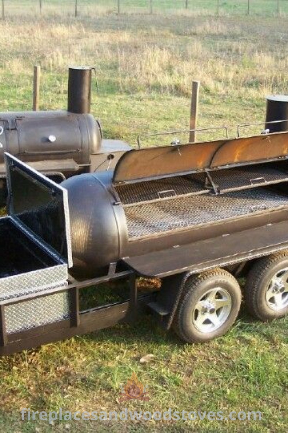 An outdoor BBQ grill sitting in the grass next to an open trailer, showcasing creative custom smoker designs ideal for backyard cookouts. Discover stylish outdoor ideas at patioandhomefurniture.com.