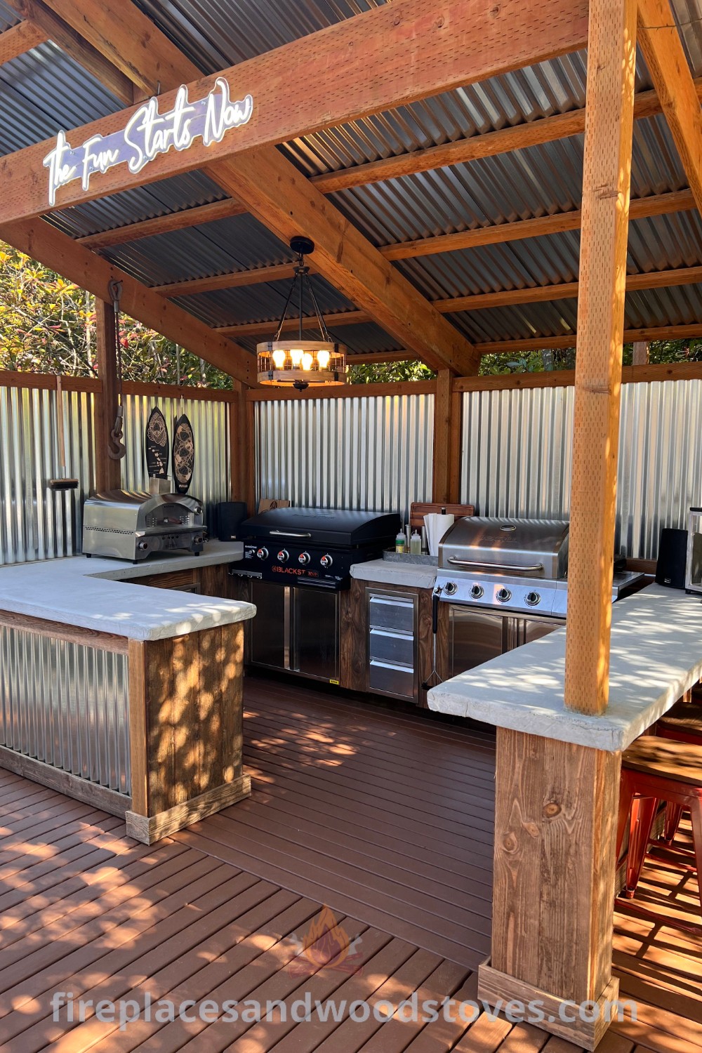 An outdoor kitchen with grills and bar stools on the decking area, showcasing stylish design and outdoor cooking functionality. Perfect for entertaining with ideas that will wow your guests. Explore more at patioandhomefurniture.com.