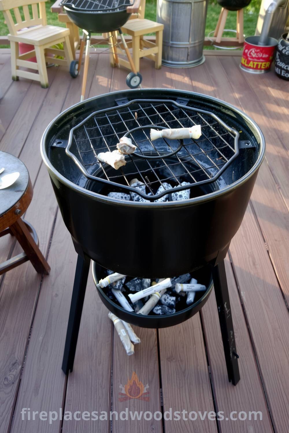 Charcoal barbecue on a weathered wooden deck surrounded by mismatched stools, with smoldering embers and long shadows cast by the golden sunset, creating a cozy and inviting atmosphere for gatherings with friends and family, featured at fireplacesandwoodstoves.com.
