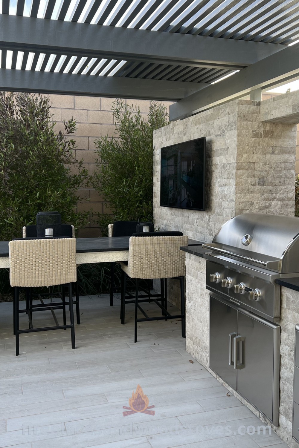 An outdoor kitchen featuring a grill and dining table, showcasing modern designs for a stylish BBQ area. Perfect for garden renovation ideas and outdoor kitchen plans that elevate your patio. Discover more inspiration at patioandhomefurniture.com.