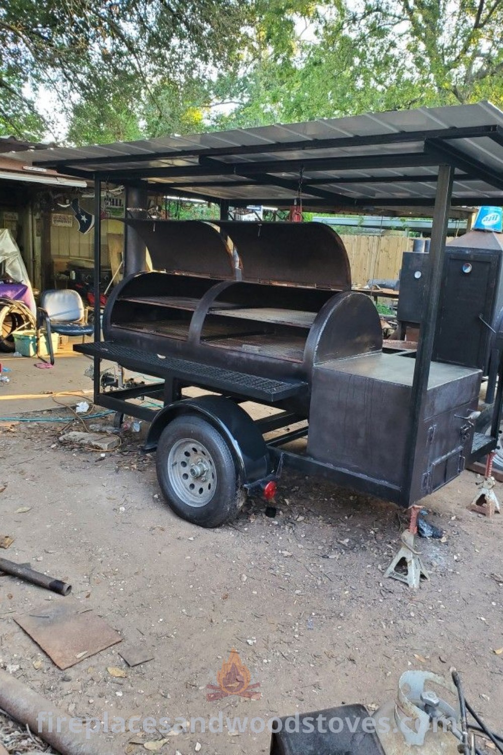 An outdoor BBQ grill setup featuring tools and equipment in a yard, showcasing custom BBQ grills and smokers designed for stylish outdoor cooking. Discover incredible backyard transformation ideas at patioandhomefurniture.com.