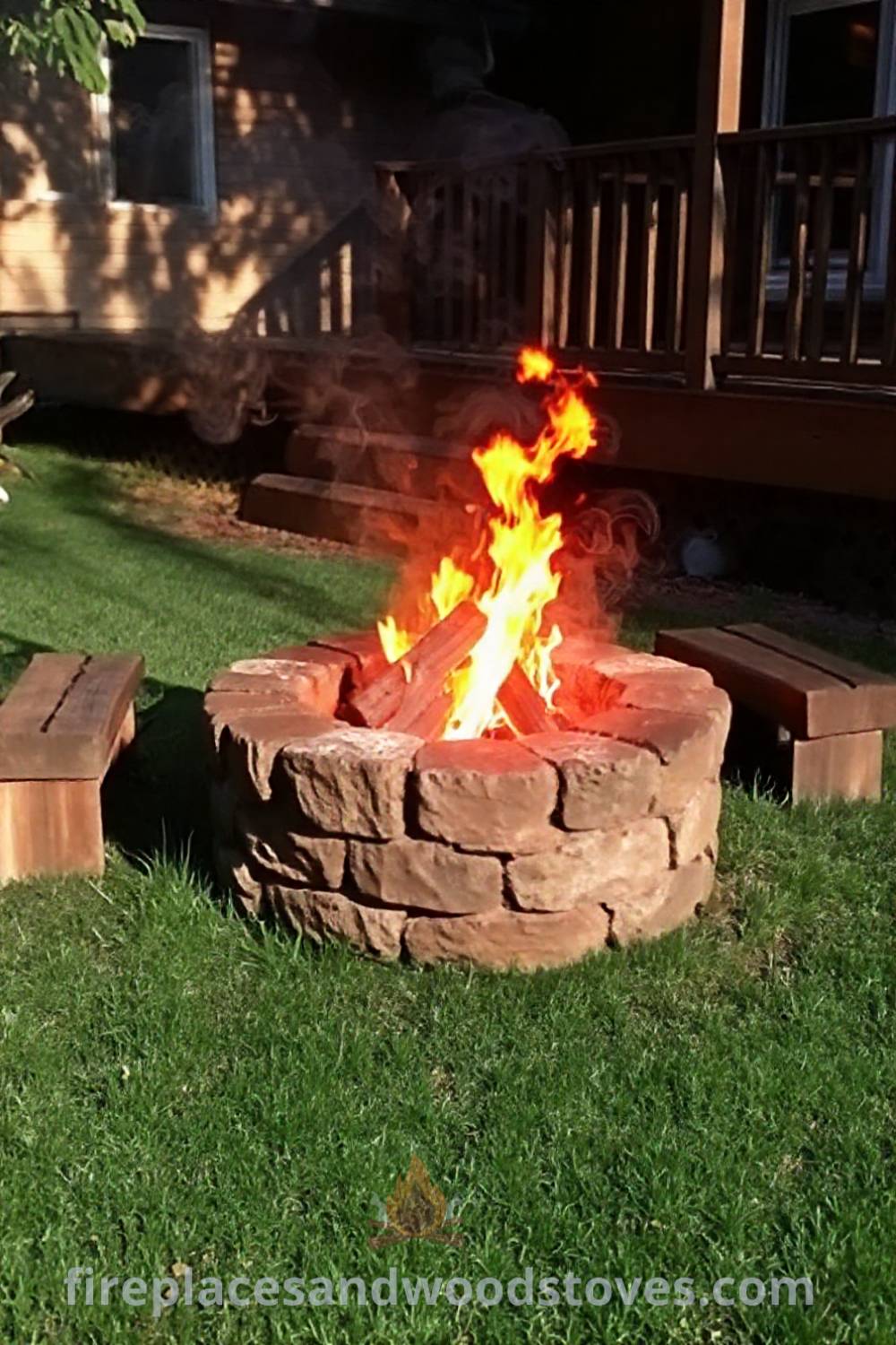 Cozy backyard with a rustic stone fire pit surrounded by log seats, providing a warm gathering spot for friends and family. Enjoy the ambiance of the flames and the evening air, perfect for creating memorable moments. Visit patioandhomefurniture.com for stylish ideas transforming your backyard.