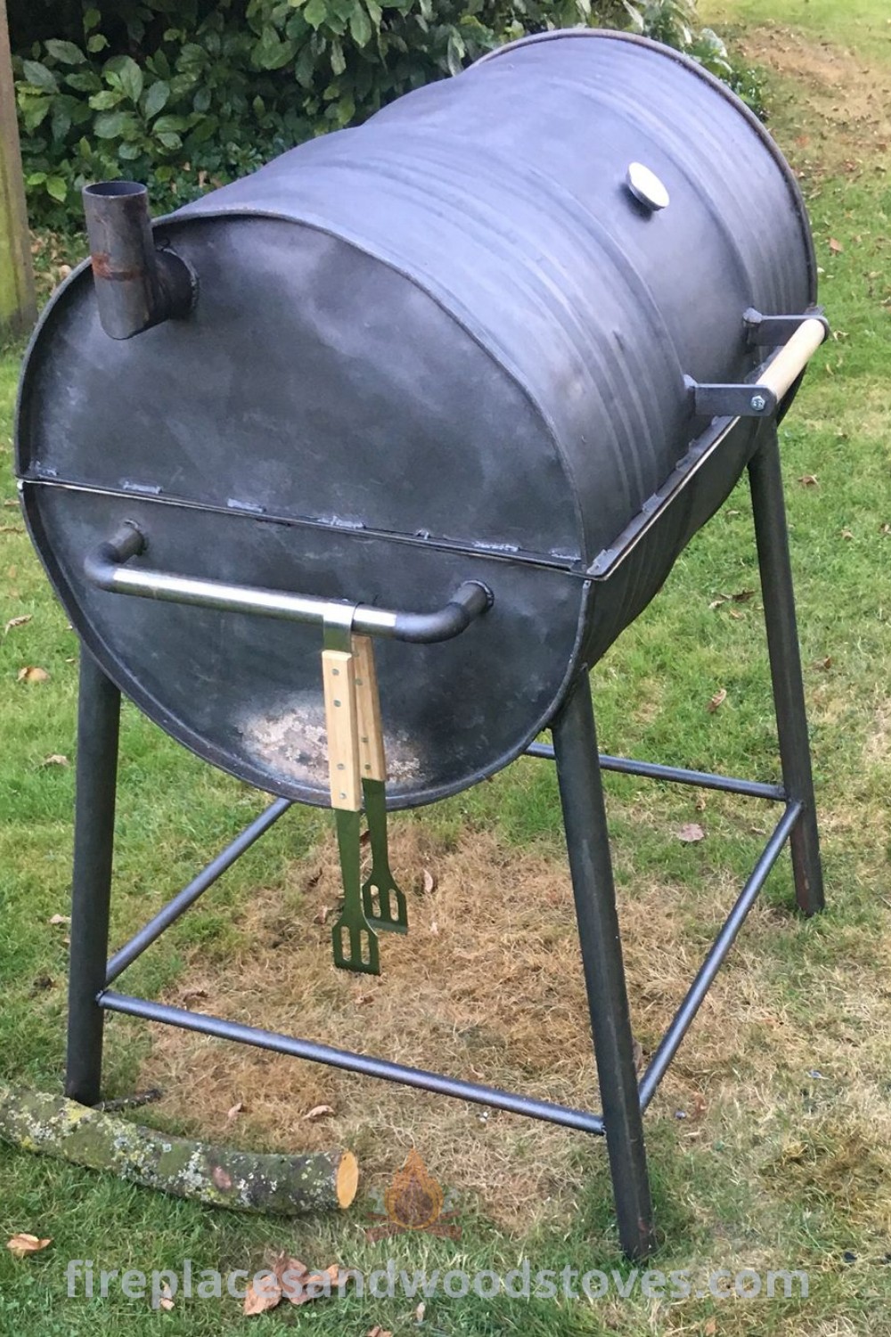 An outdoor BBQ grill sitting in the grass, showcasing a stylish design ideal for backyard gatherings. Perfect for charcoal grilling, poultry equipment, and fire pit BBQs. Explore more incredible outdoor ideas at patioandhomefurniture.com.