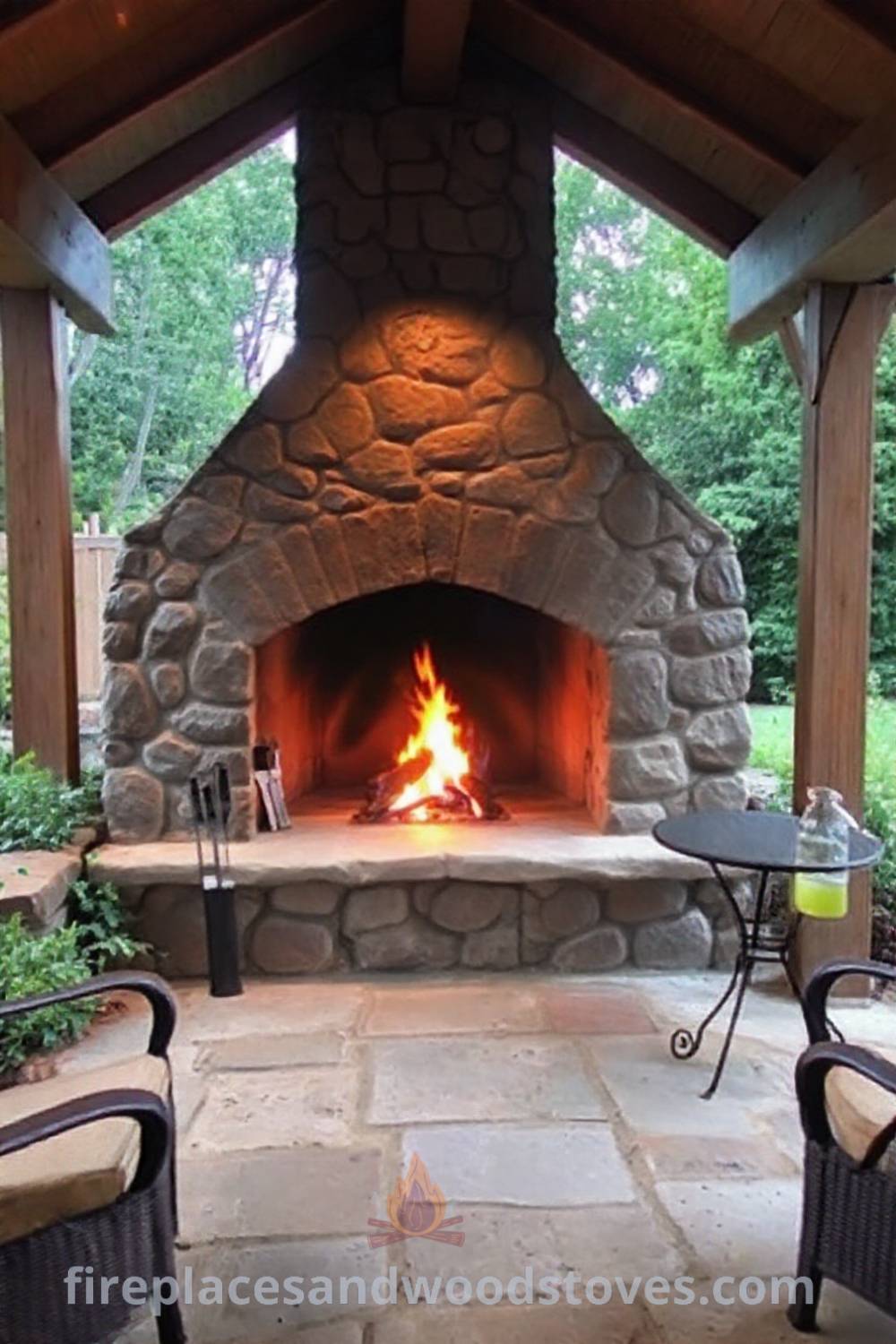 Fireplace BBQ set in a cozy backyard patio, featuring rugged stone and wooden beams, surrounded by greenery, inviting gatherings with friends. Visit patioandhomefurniture.com for stylish outdoor ideas you