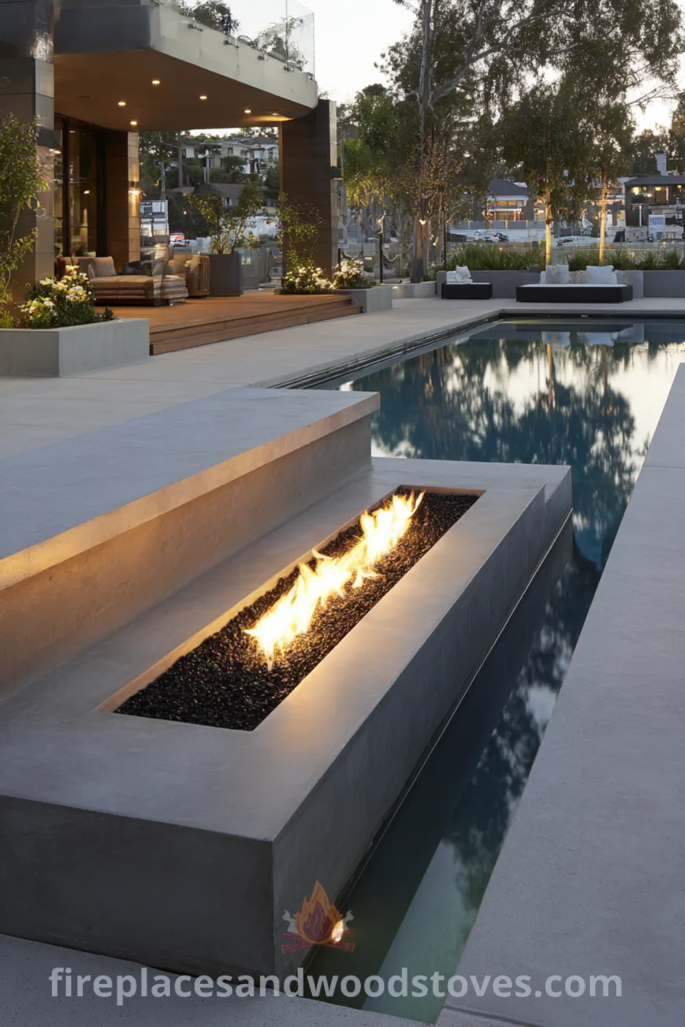 Modern fire pit with built-in concrete seating, polished surface, and poolside setting in a sophisticated outdoor space.
