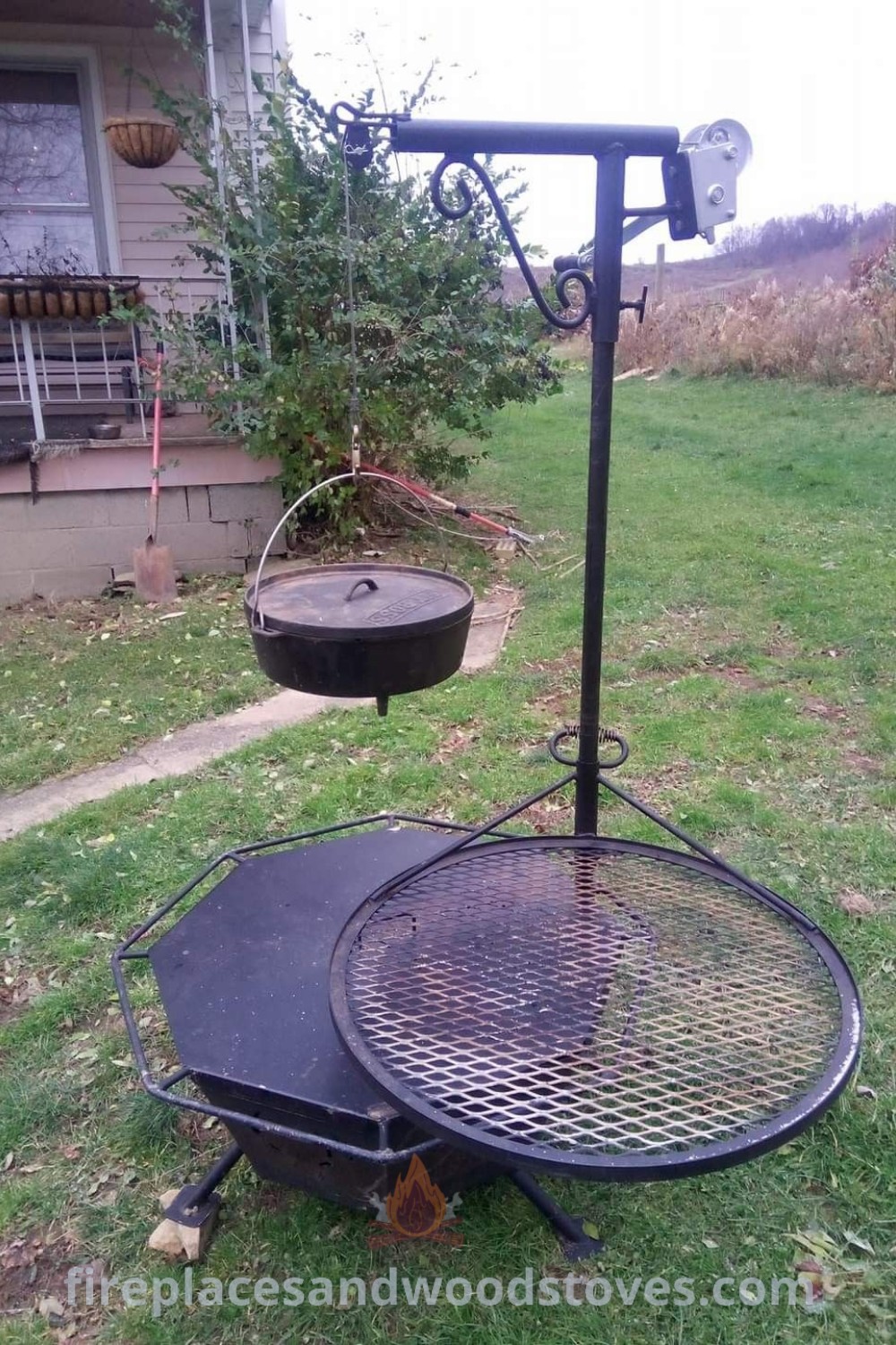 An outdoor grill nestled in the grass beside a house, featuring a bird feeder. This stylish setup encourages cozy gatherings while showcasing incredible barbecue design and cooking equipment ideas perfect for transforming your backyard. Explore more grilling inspiration at patioandhomefurniture.com.