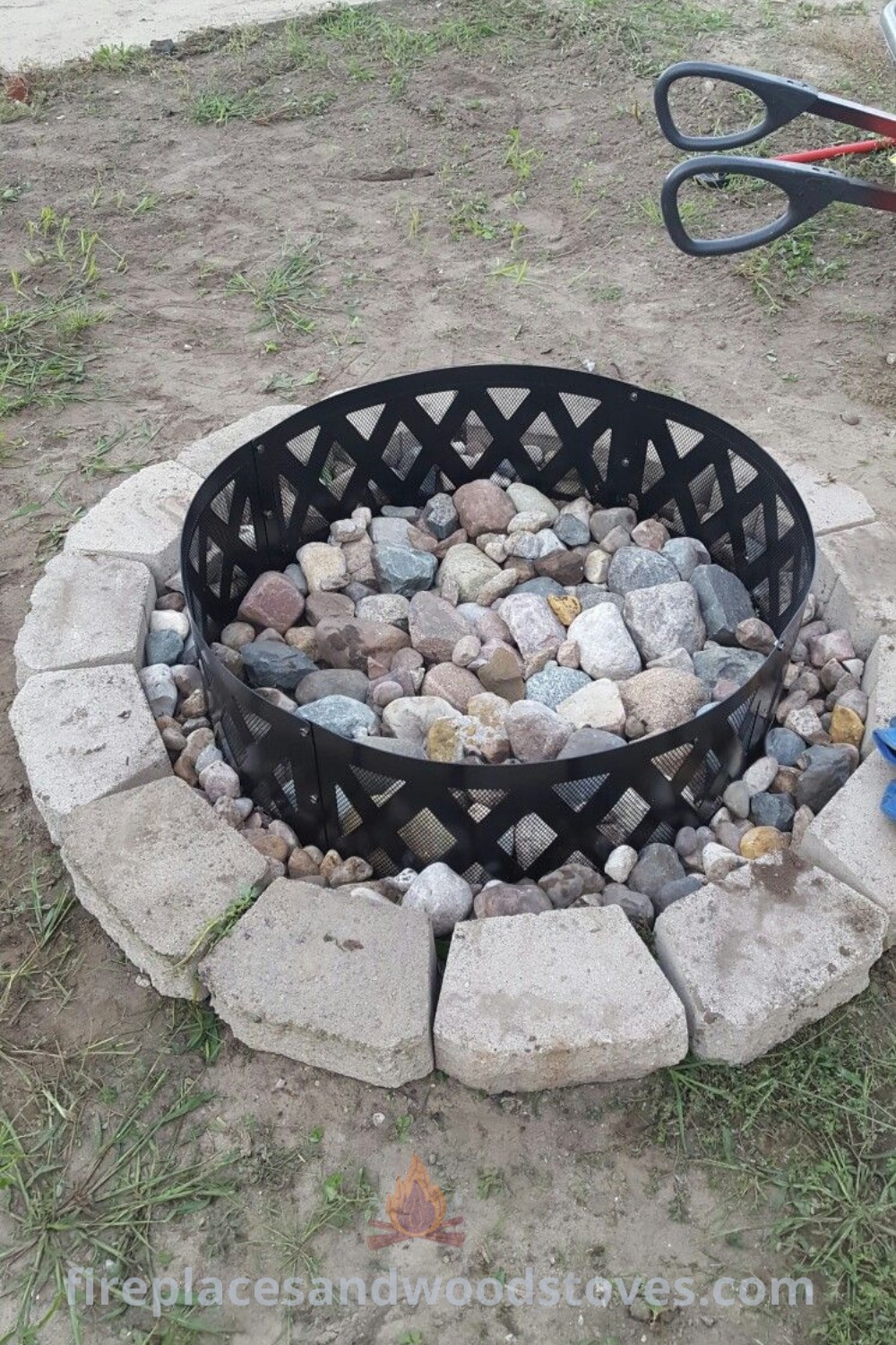 An outdoor fire pit with rocks and gravel around it, showcasing stylish designs for backyard inspiratiozn. Discover incredible ideas for fire rings, cozy campground setups, and outdoor entertaining at patioandhomefurniture.com.