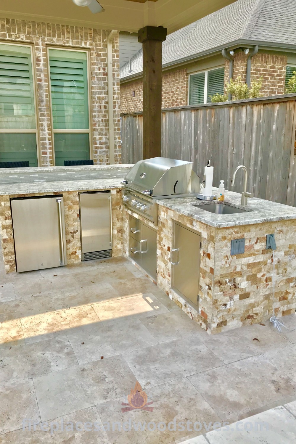 An outdoor kitchen featuring a grill, sink, and refrigerator, perfect for entertaining and cooking in style. This design enhances the aesthetics and functionality of your patio. Discover more incredible ideas at patioandhomefurniture.com.
