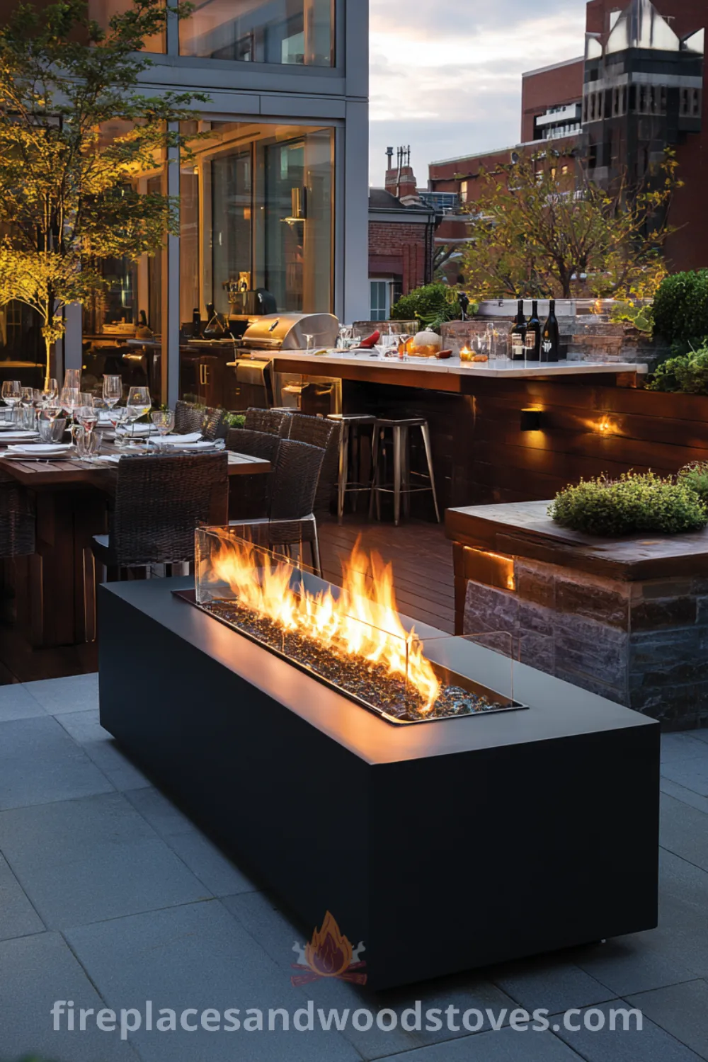 Modern fire pit centerpiece in an elegantly designed outdoor kitchen area featuring built-in seating, integrated lighting, and a sophisticated ambiance.