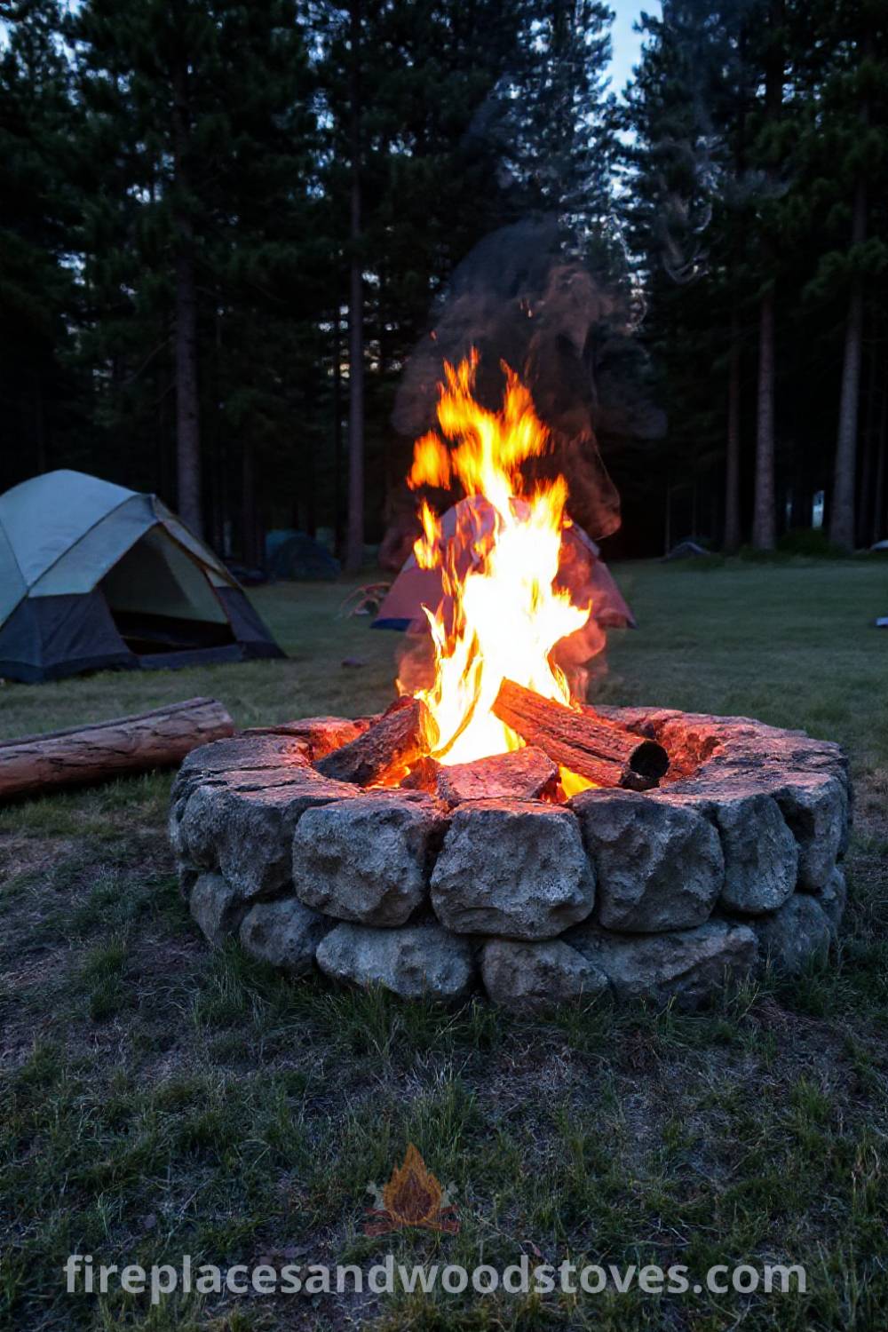Stone fire pit in a campsite surrounded by tall pines, with flickering flames illuminating nearby tents and inviting logs for campers to sit on, creating a cozy outdoor retreat. Visit patioandhomefurniture.com for stylish outdoor ideas that will wow your guests.