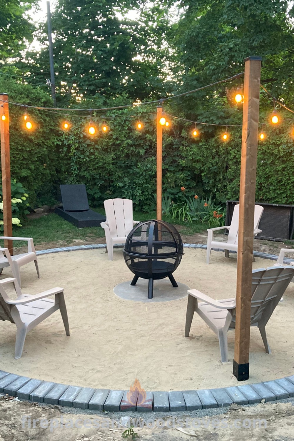 An outdoor seating area with chairs, lights, and a fire pit, perfect for gatherings. This stylish fire pit landscaping creates a cozy atmosphere for friends and family, featuring incredible outdoor ideas at patioandhomefurniture.com.