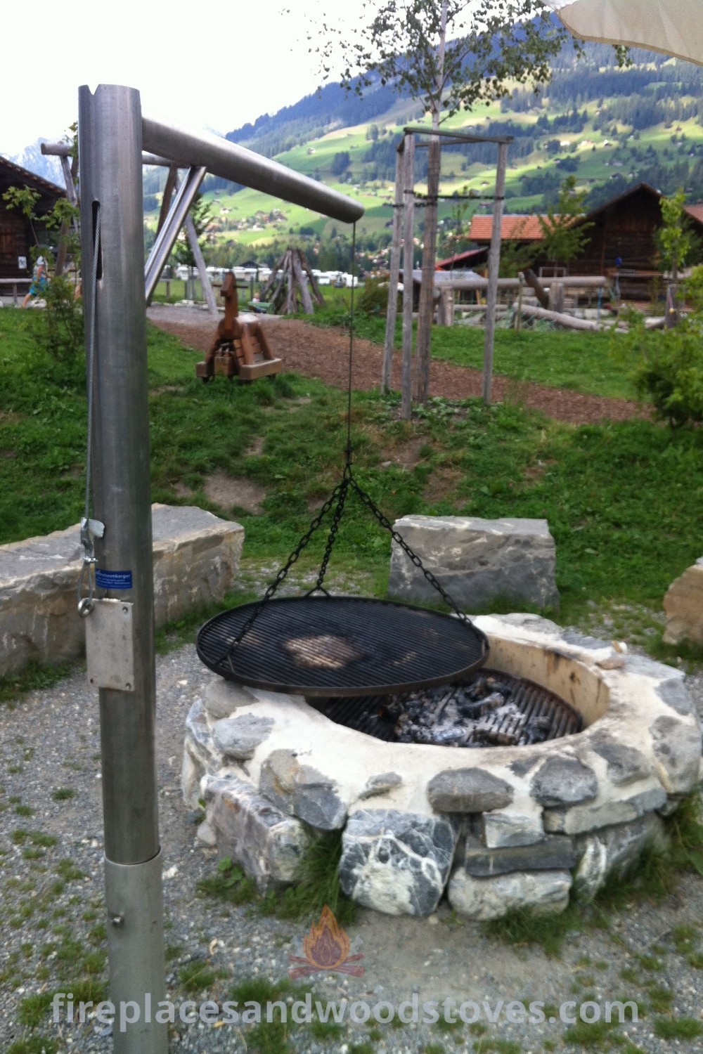 An outdoor fire pit surrounded by grass, serving as a cozy gathering place for BBQs and camping, showcasing stylish designs for outdoor kitchens. Explore more incredible ideas at patioandhomefurniture.com.