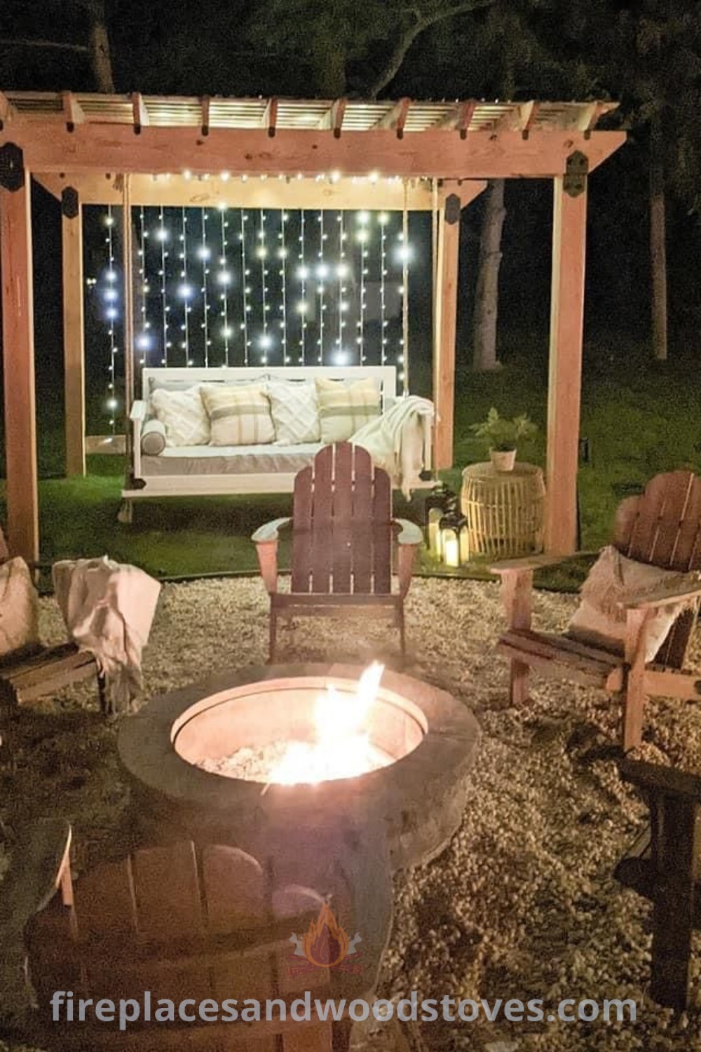 An outdoor fire pit with chairs and lights shining on the wall behind it, creating a cozy atmosphere ideal for summer evenings. Discover stylish backyard fire pit landscaping ideas that inspire relaxation and connection with nature at patioandhomefurniture.com.