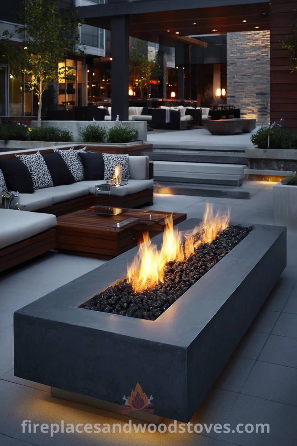 Contemporary backyard setting with modern luxury fire pit surrounding elegant furniture, ambient LED lighting, and sophisticated atmosphere.