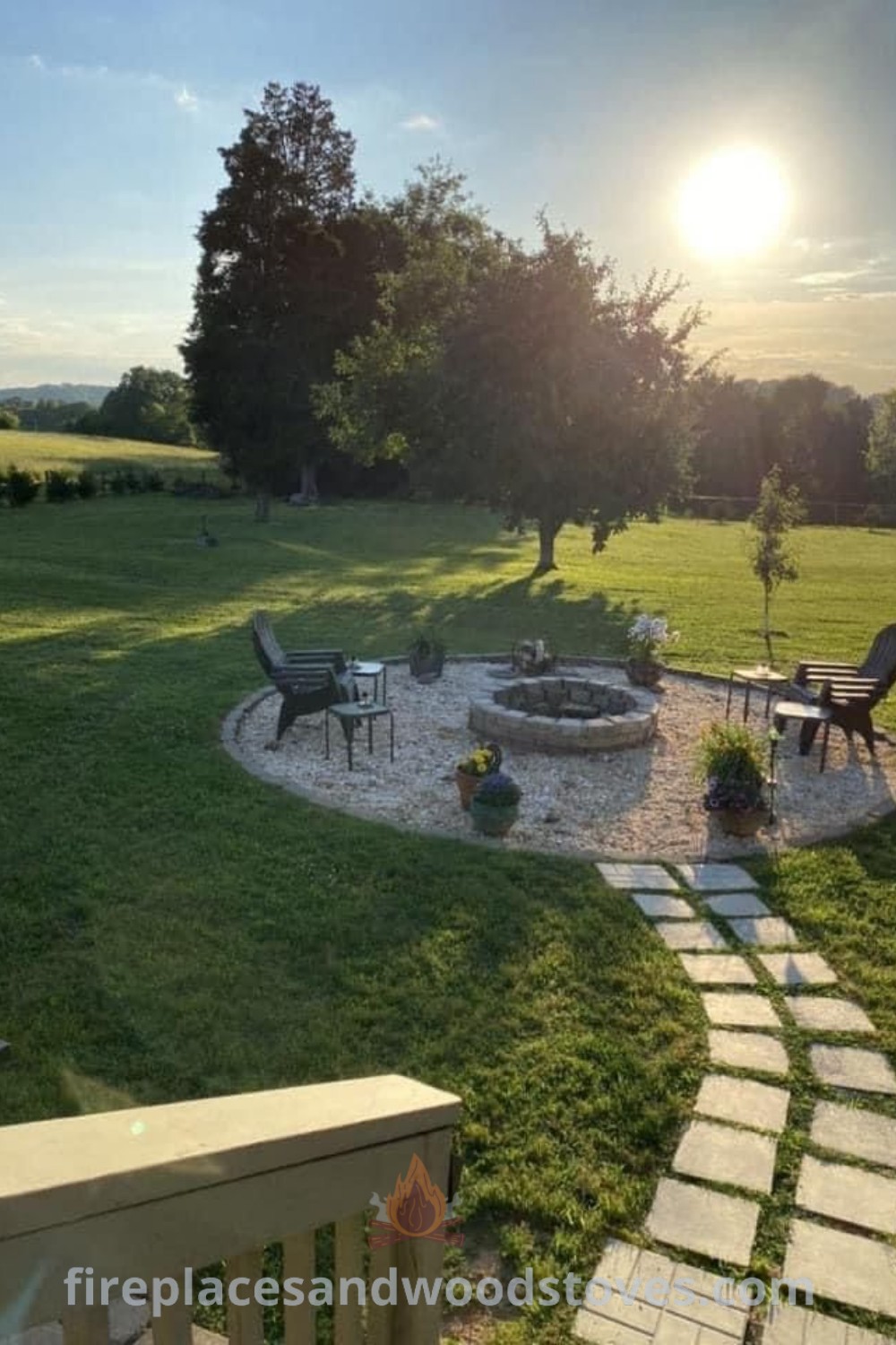An outdoor fire pit area surrounded by grass, chairs, and tables, ideal for social gatherings. Discover stylish and functional fire pit designs for your backyard at patioandhomefurniture.com.