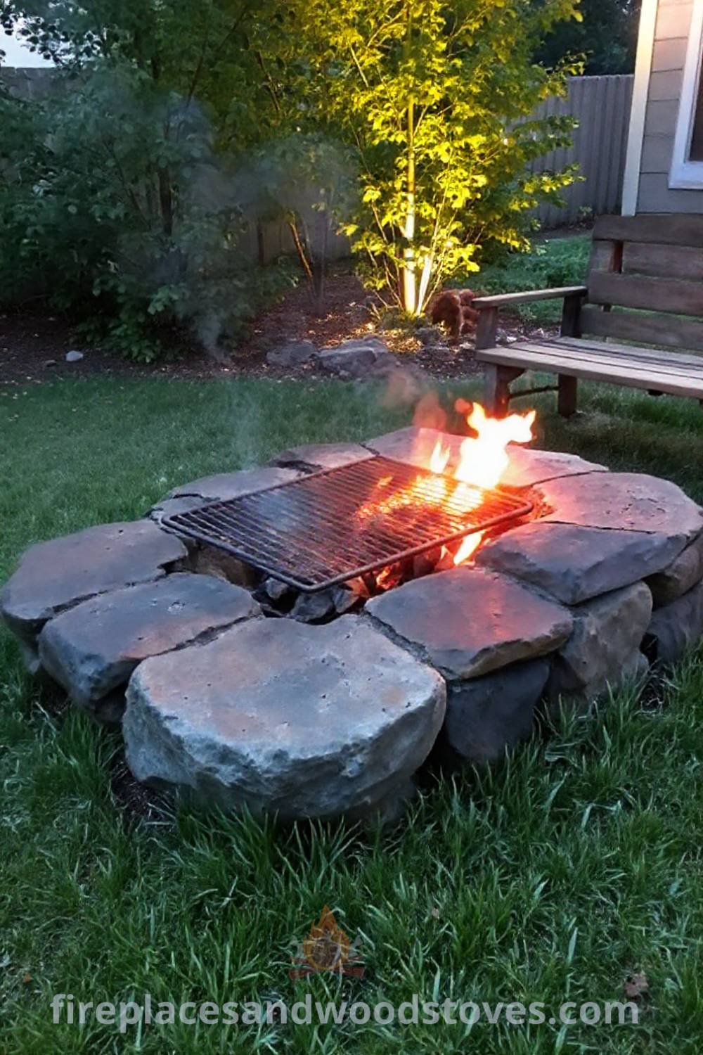 Stone charcoal fire pit with grill grate in a cozy backyard setting, surrounded by green grass and a rustic wooden bench, creating an inviting atmosphere for gatherings. Visit patioandhomefurniture.com for stylish outdoor design ideas that will wow your guests.