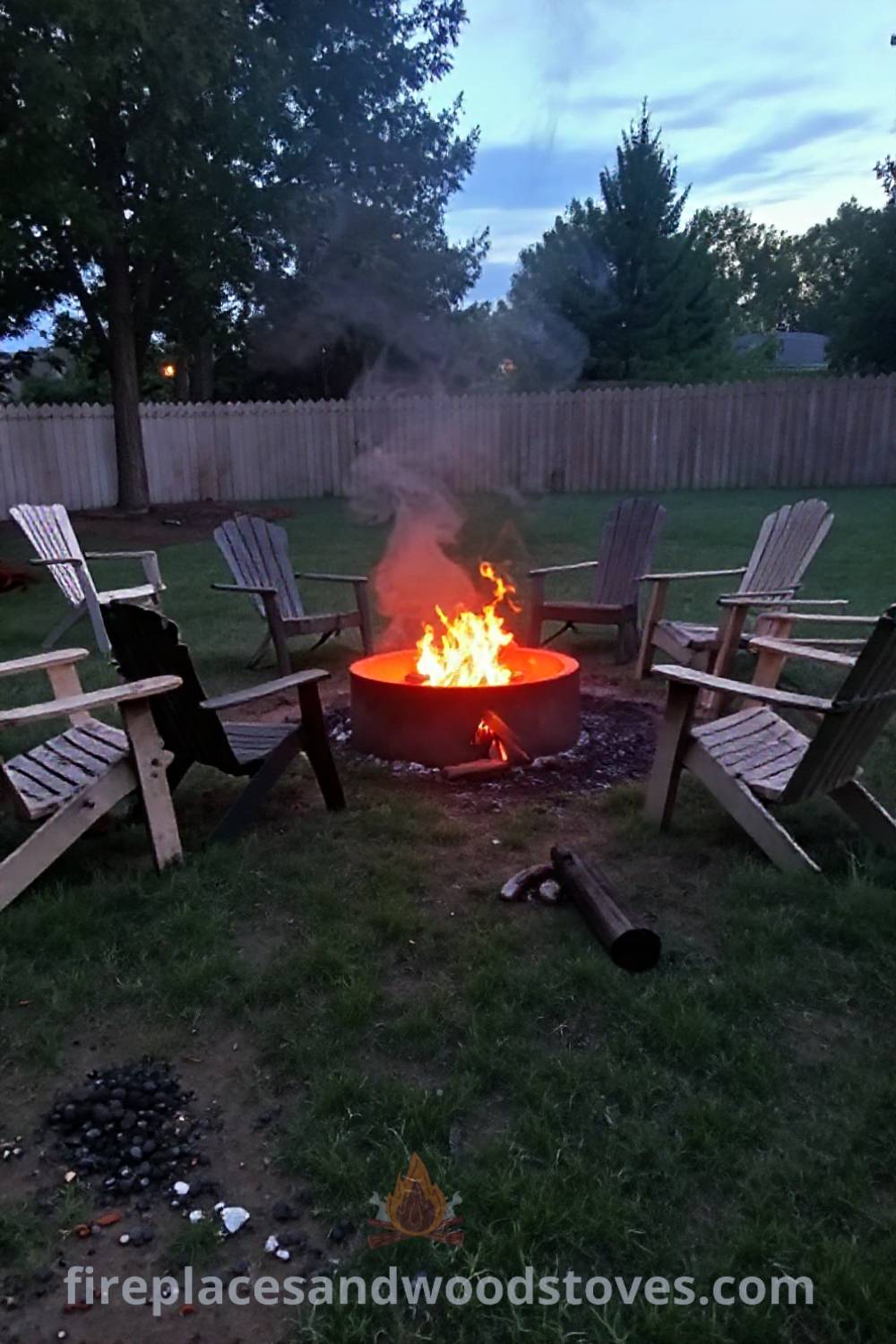 Charming backyard charcoal fire pit surrounded by assorted outdoor chairs, casting warm light and creating a cozy atmosphere, perfect for gatherings. Visit patioandhomefurniture.com for stylish ideas transforming your backyard into a dream space for entertaining guests.