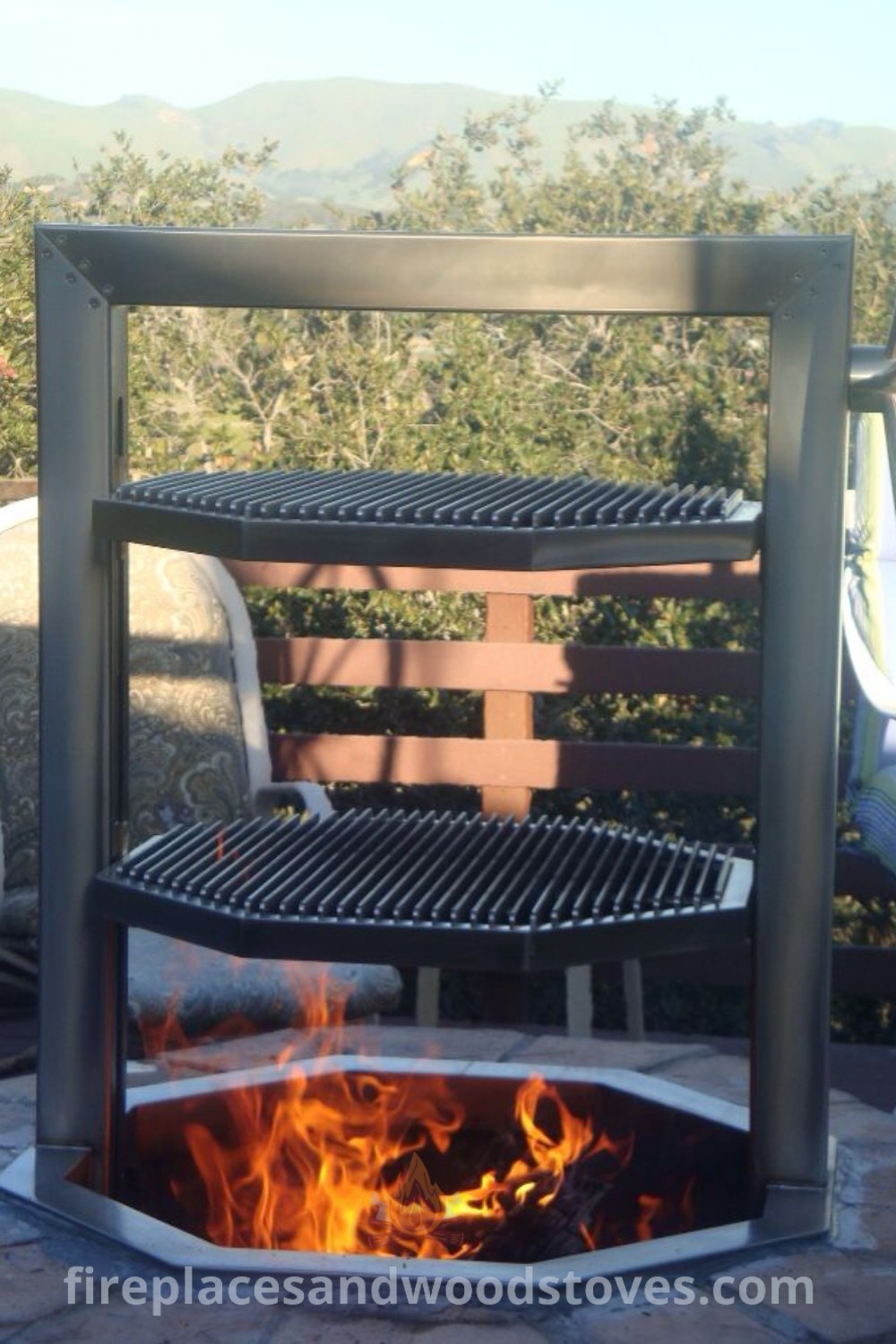 A cozy fire pit sitting on a stone patio, perfect for backyard BBQ ideas and gatherings. Featuring a Santa Maria BBQ grill and fire pit rotisserie, this setup enhances outdoor entertaining. Discover more stylish outdoor inspiration at patioandhomefurniture.com.