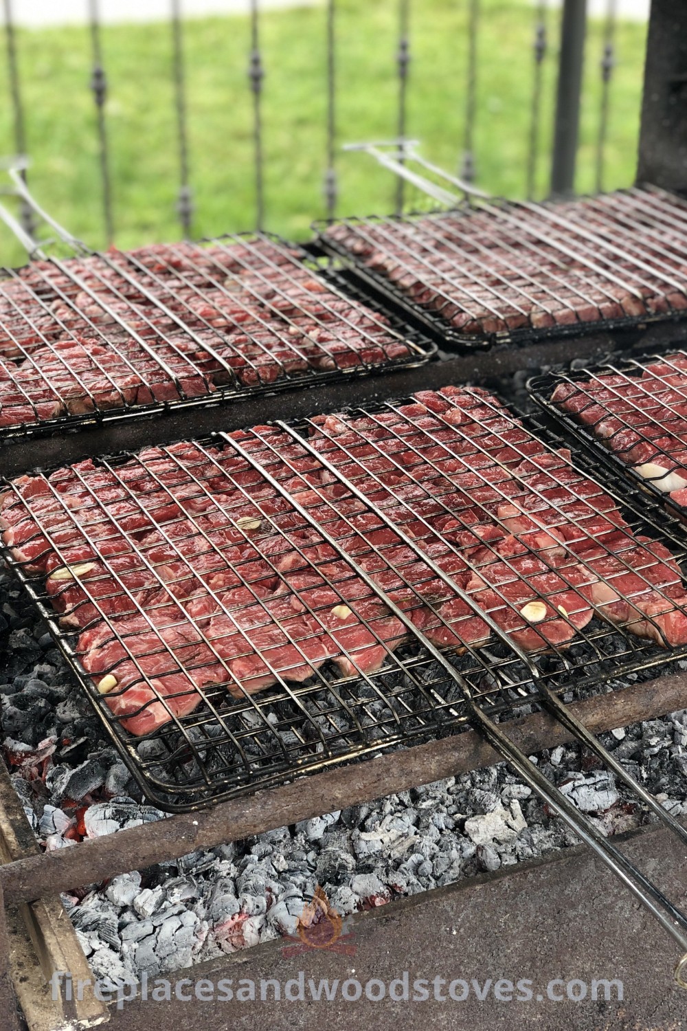 Hamburger patties cooking on the grill with charcoal, showcasing delicious BBQ food perfect for a party buffet. Enhance your outdoor gatherings with cozy and stylish ideas that transform your backyard into an incredible space. Explore more at patioandhomefurniture.com.