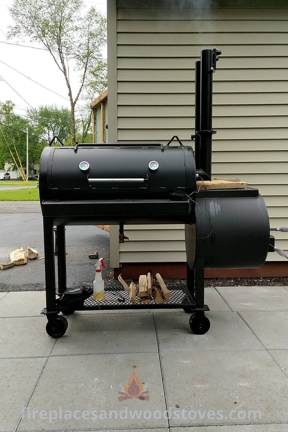 A stylish BBQ grill sitting on a sidewalk next to a building, showcasing an elegant barbeque grill design perfect for outdoor cooking and gatherings. Discover incredible outdoor ideas and designs at patioandhomefurniture.com.