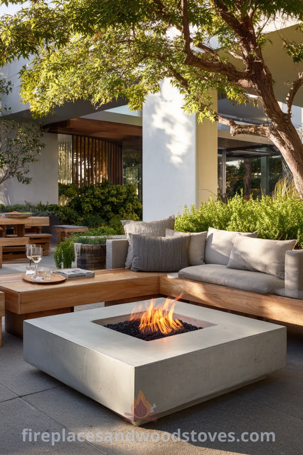 Outdoor mid-century modern corner fireplace with polished concrete slabs, nestled in a lush garden landscape, offering sleek outdoor corner hearth and inviting social hub.