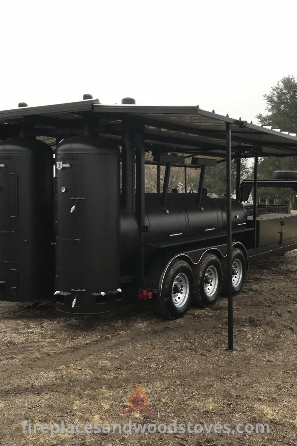 A black food truck with a canopy parked in a dirt field, showcasing custom BBQ smokers and pit cooking designs, ideal for outdoor events. Explore more food truck ideas at patioandhomefurniture.com.