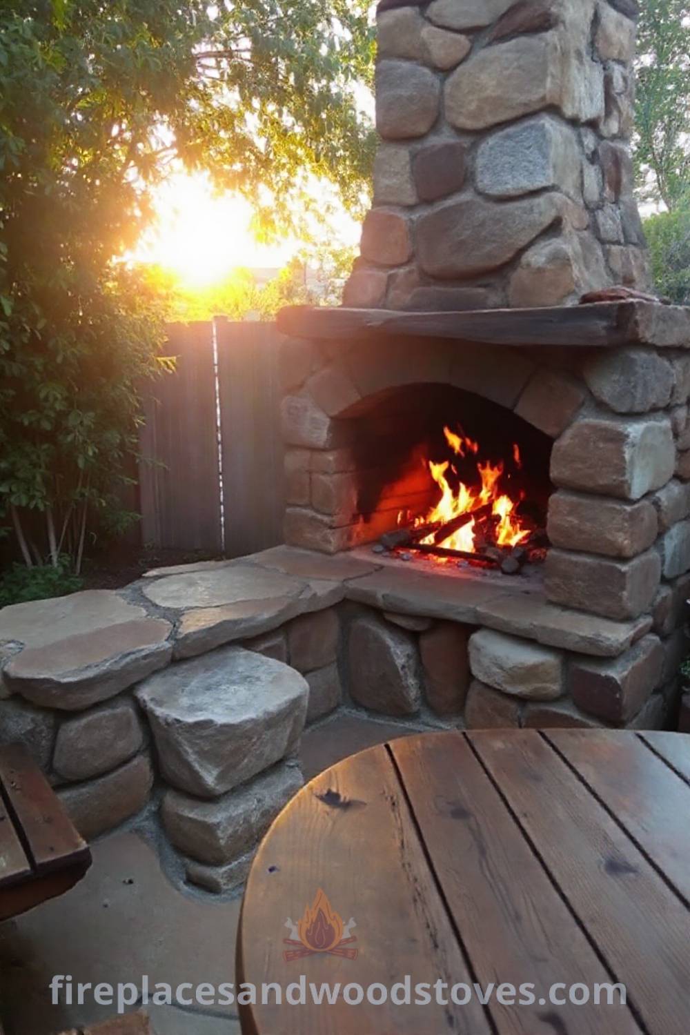 Outdoor fireplace BBQ made from uneven stones, flames crackling and illuminating a wooden table with grill tools, creating a cozy and inviting atmosphere for gatherings, showcasing incredible ideas for transforming your backyard. Visit patioandhomefurniture.com for stylish inspiration.