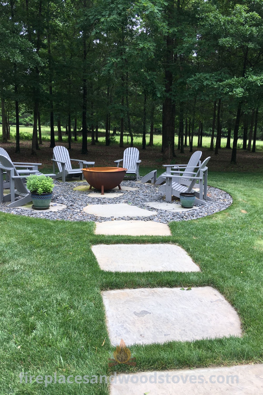 A cozy stone patio with chairs and a fire pit, creating the perfect backyard sitting area for relaxation and gatherings. Discover stylish designs for outdoor fire pit areas at patioandhomefurniture.com.