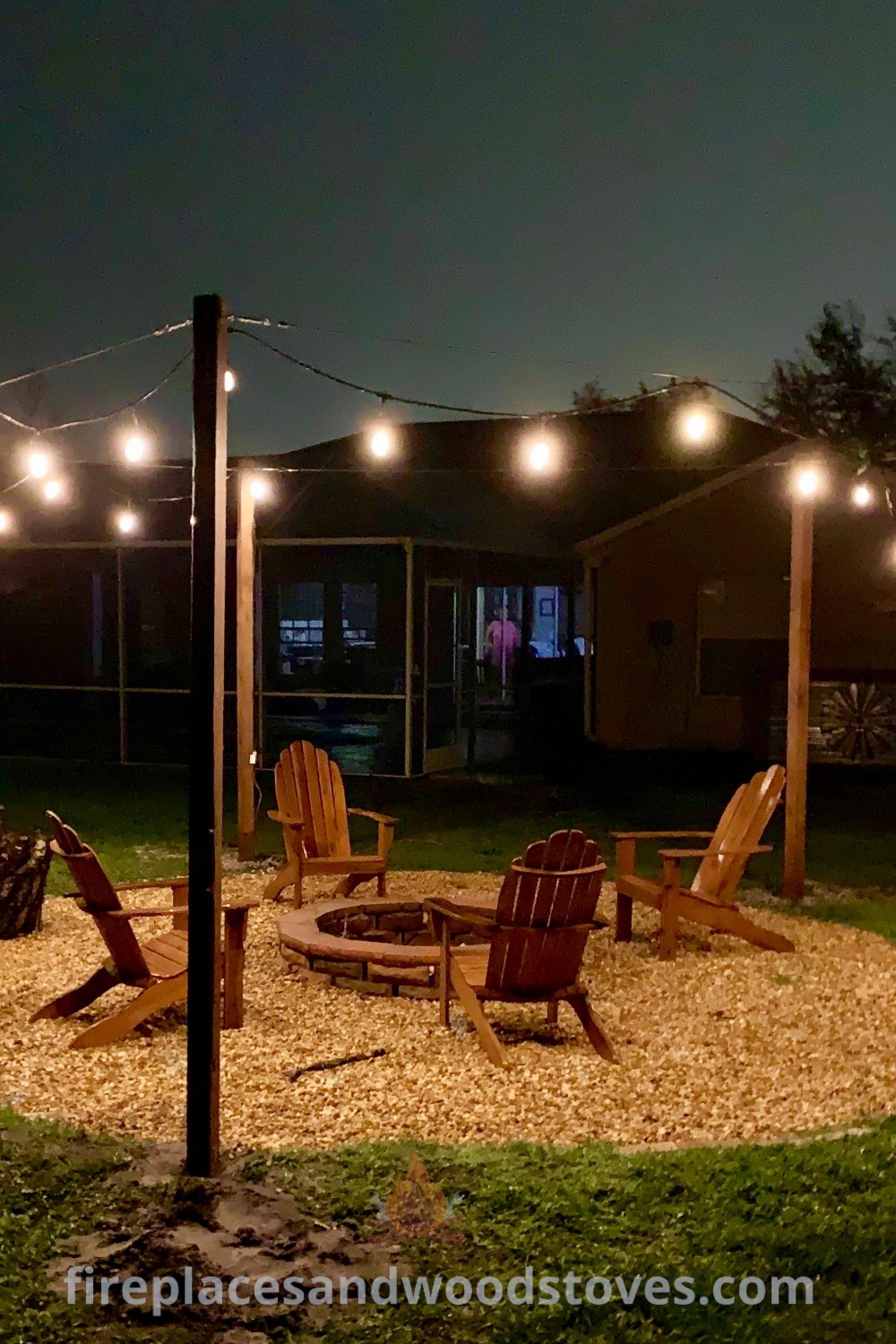 An outdoor fire pit surrounded by lawn chairs and string lights under the night sky, showcasing creative backyard bonfire ideas and fire ring designs. This setup offers cozy aesthetics and functional benefits for an entertaining space. Discover more outdoor inspiration at patioandhomefurniture.com.