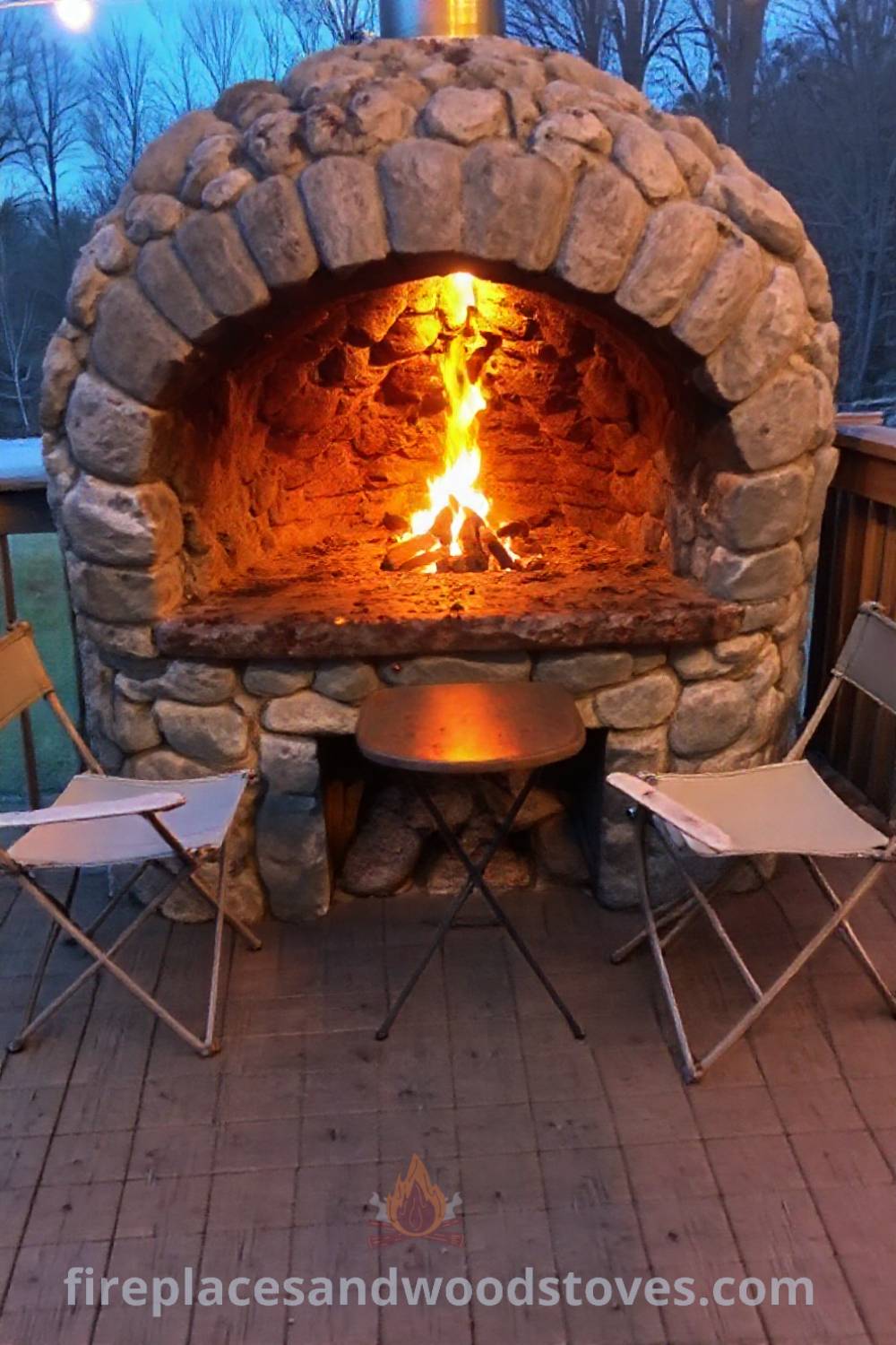 Stone BBQ oven on a wooden deck, surrounded by folding chairs and a small table, creating a cozy outdoor gathering spot perfect for grilling and enjoying time with loved ones, including ideas for transforming your backyard into a stylish retreat. Visit patioandhomefurniture.com for incredible ideas.