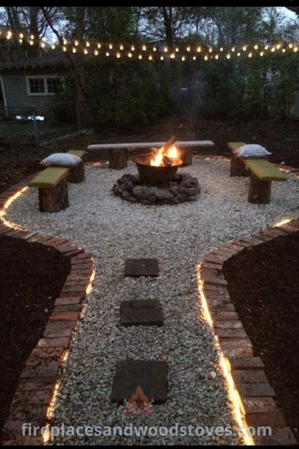 A beautifully designed fire pit surrounded by stones and decorative lights, showcasing outdoor fire pit designs and landscaping ideas. Transform your backyard into a cozy gathering space with stylish decor from patioandhomefurniture.com.