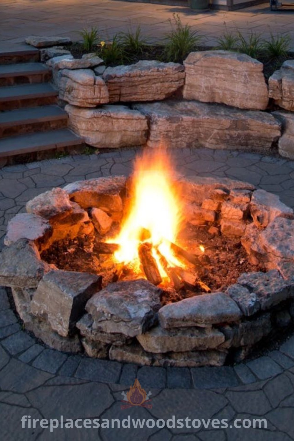 A fire pit sitting in the middle of a stone walkway next to steps and stairs, enhancing the outdoor space with stylish and functional design ideas. Discover more about brick patio with fire pit and outdoor inspirations at patioandhomefurniture.com.