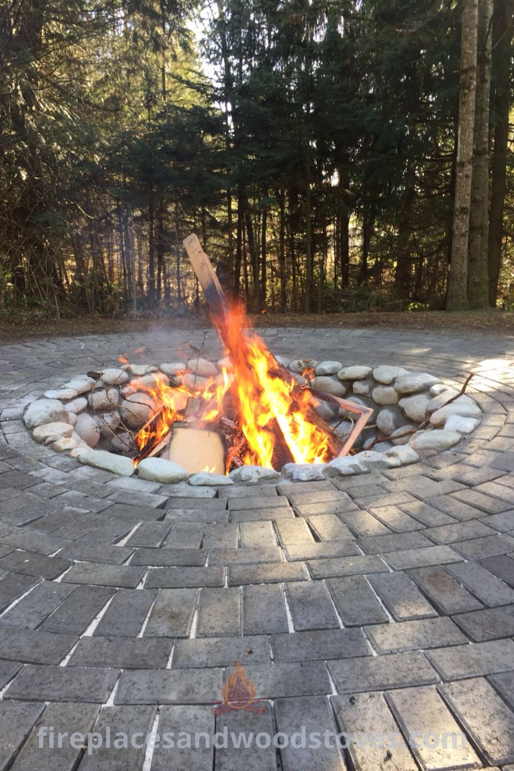 A beautiful garden fire pit surrounded by rocks, showcasing stylish outdoor fire pit ideas and creative landscaping designs. Perfect for cozy gatherings, this multifunctional space enhances any backyard with its aesthetic appeal. Discover more inspiration at patioandhomefurniture.com.